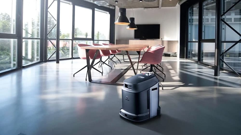 Autonomous cleaning robot in modern office with natural light